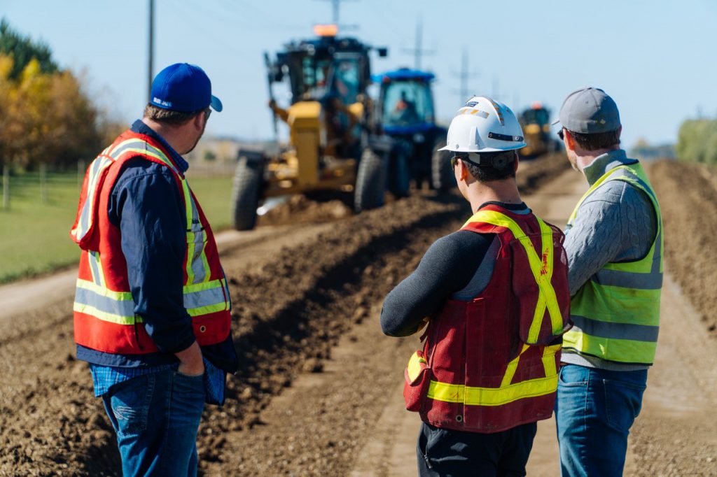 Riley Cram observes ROAD//STABILIZR® application at Curry's Landing near Cornwallis, Manitoba.
