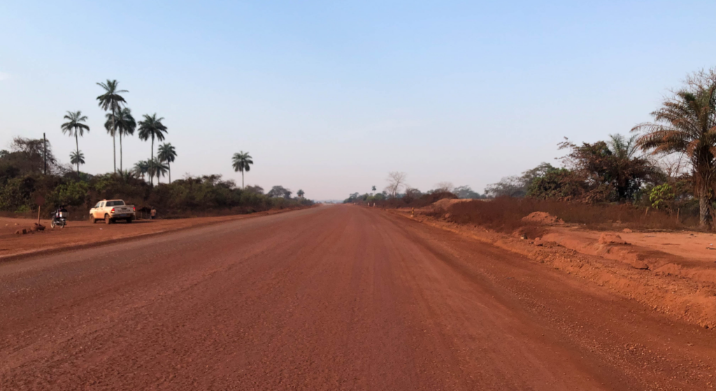 Road in Guinea after being treated with organic dust control.
