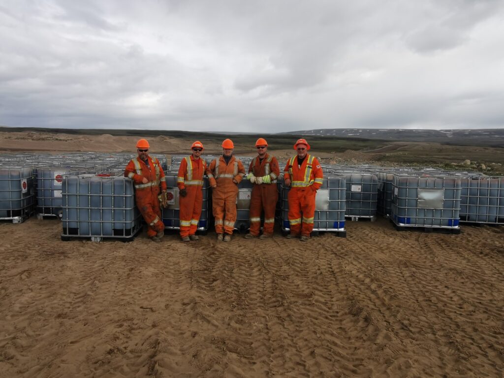 team members standing at iron mine