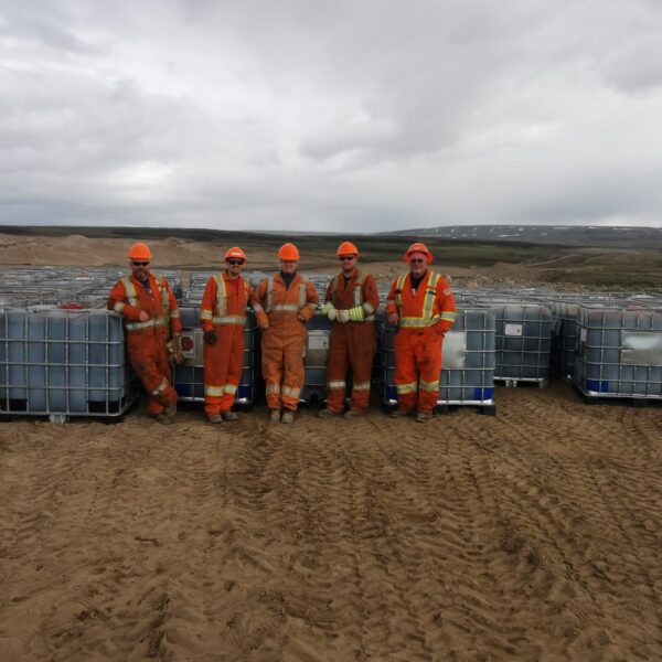 team members standing at iron mine